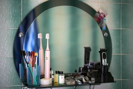 Concept image of clay doll representing couple, man, woman, their house, two trees on blue background. Happy doll of white color and simple style. Horizontal position.の写真素材