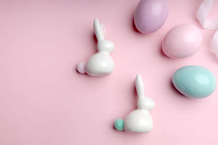 Easter bunnies and eggs on a pink background, flat lay, copy spaceの写真素材