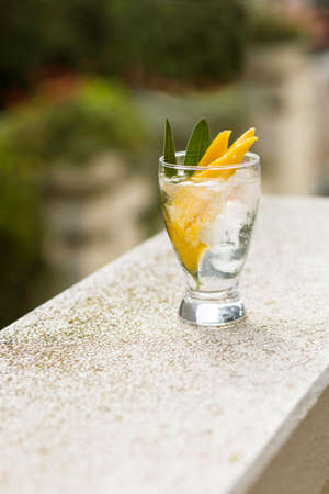 Glass of summer cool drink with mango and ice cubeの写真素材