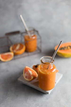 Papaya and orange smoothies, healthy vegetarian and vegan food.の写真素材