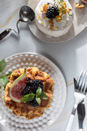 Camembert cheese with figs, walnuts, thyme and honey on a white marble table .French dessertの写真素材
