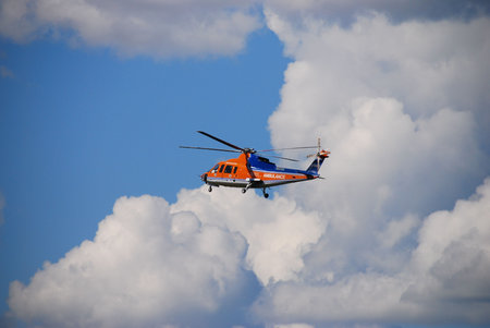 An air ambulance lowers its landing gear as it comes in for a landing.