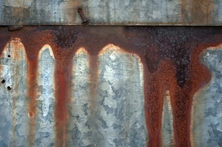 Streaks of rust on a metal baking sheet の写真素材