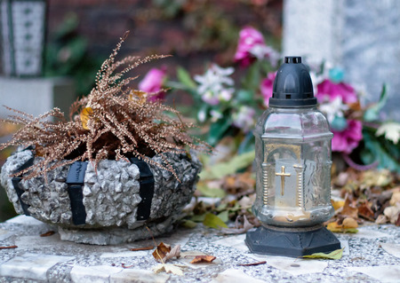 Autumn cemetery, candles and fallen leaves.の写真素材