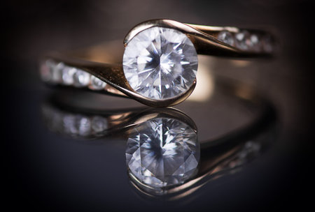 Gold ring with diamonds on a black background.