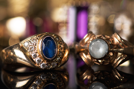 Gold jewelry on a black background.の写真素材