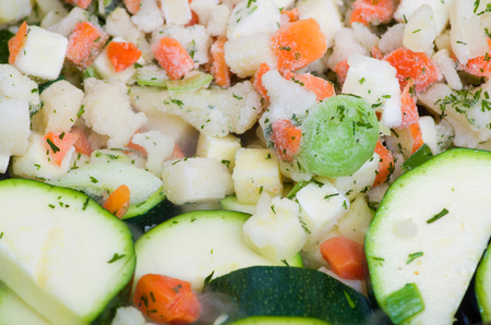 A mixture of raw and frozen vegetables sprinkled with dill.の写真素材