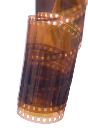 A roll of photographic film of 135 mm on a white background.の写真素材