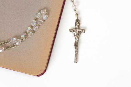 Rosary and old notebook on a white background.の写真素材