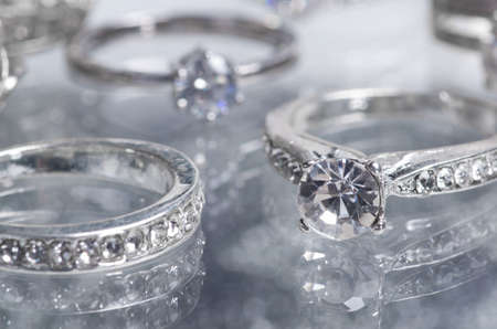 Silver rings. A thick ring with many crystals, an engagement ring and a Valentine's Day ring with a heart-shaped eyelet.の写真素材