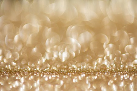 Shiny background, shimmering texture full of reflections and tinsel in color gold.の写真素材
