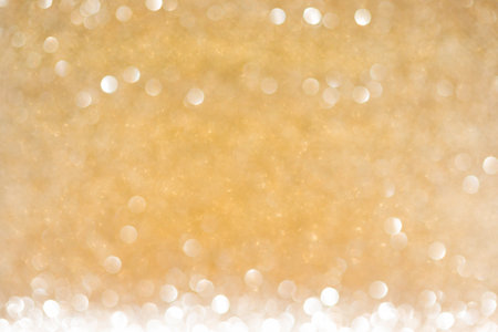 Shiny background, shimmering texture full of reflections and tinsel in color gold.の写真素材