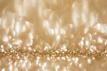 Shiny background, shimmering texture full of reflections and tinsel in color gold.の写真素材