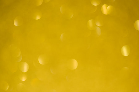 Shiny background, shimmering texture full of reflections and tinsel in color yellow.の写真素材