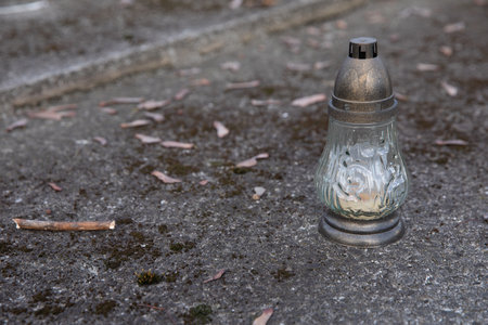 An old candle on an old grave in the cemetery.の写真素材