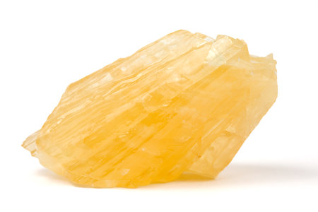 A raw nugget of yellow calcite from Poland. A mineral from the carbonate group.の写真素材