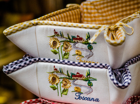 Bread basket of cloth with embroidered above a Tuscany landscapeの写真素材