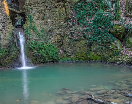 Ruins of a water mill in Tuscany with a waterfall That passes throughの写真素材