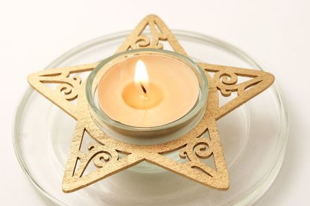 Macro shot of a beautiful small lit candle.の写真素材