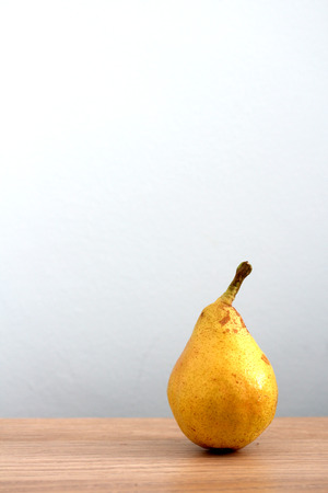 Ripe pear on desk backgroundの写真素材