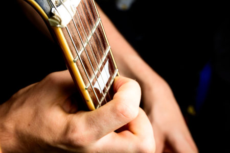 Sun burst electric guitar played by man