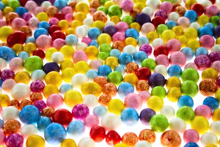 Many nice colorful small polysterene balls on backgroundの写真素材