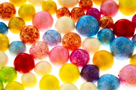 Many nice colorful small polysterene balls on backgroundの写真素材