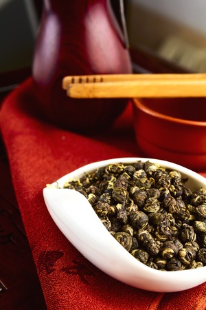 Chinese tea on wood plate background and rice paperの写真素材