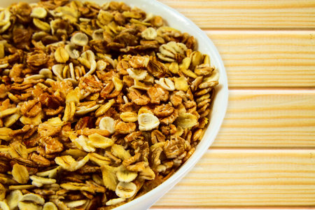 Oatmeal porridge close up on wooden background