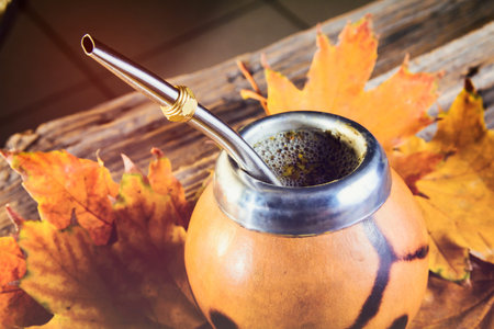 Mate gourd on vintage wooden table close up