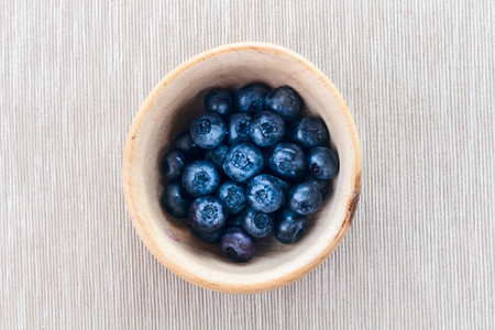 Blueberries in mortar on towelの写真素材