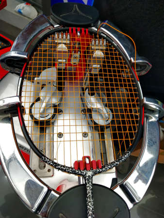 Top view of Stringing badminton racket on the racquet weaving machineの写真素材