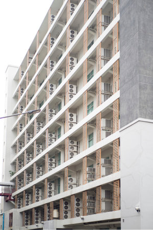 A lot of compressor airs at balcony  of office building in city.の写真素材