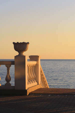 Seafront balustrade in the light of setting sunの写真素材