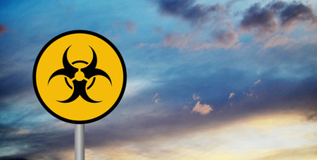 Yellow biohazard sign against blue and orange sky with clouds, 3d renderの写真素材