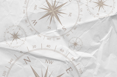 compass on crumpled paper as a background, top viewの写真素材