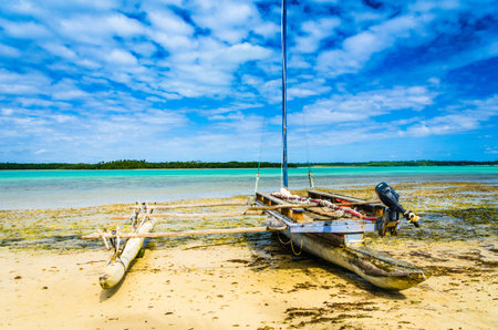 Empty traditional wooden boat on an empty and dry beach