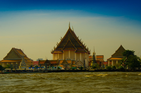 Historical building of temple and royal palace by the edge of the river in tropical Asian countryの写真素材
