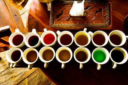 Vendor selling various types of coffee and tea in the cups in local traditional open marketの写真素材