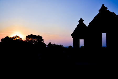 Sunset silhouette of ruins of traditional old heritage stone medieval temple in East Asia in an archaeological complexの写真素材