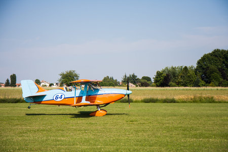 light aircraft, modern biplane orange and blue details and takeoff