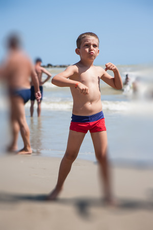 little boy dance on beach at the day timeの写真素材