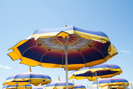 close up multicolored umbrellas beach, blue, yellow, orangeの写真素材