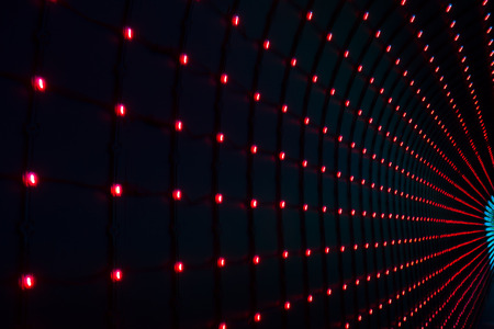 dark background with multicolored LEDs in perspectiveの写真素材