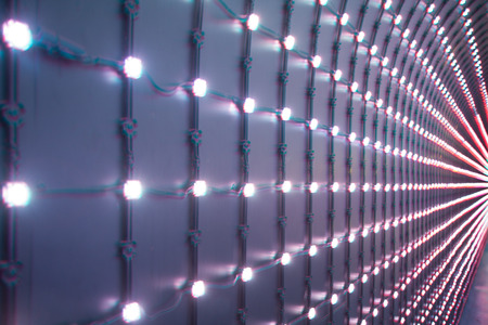 dark background with multicolored LEDs in perspectiveの写真素材