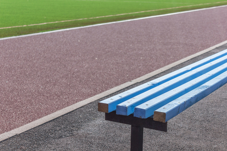 Wooden benches seats for fans on soccer football fieldの写真素材