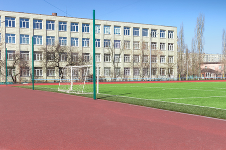 Soccer football field near urban school buildingの写真素材