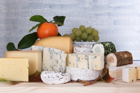 Many cheese kinds on a wooden plateの写真素材