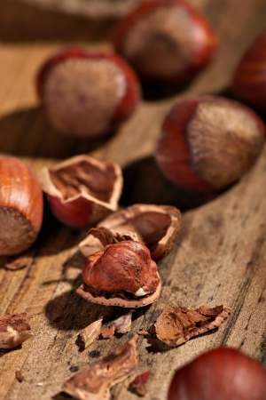 Several hazelnuts on a wooden board の写真素材
