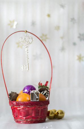 Red wicker basket with gifts and tangerinesの写真素材